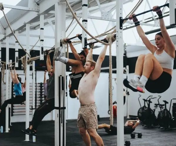 Members working out pull up